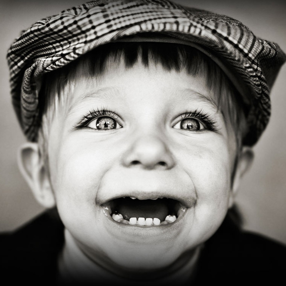 A young boy smiling enthusiastically, a perfect description for how Amplify tackles branding and marketing challenges.